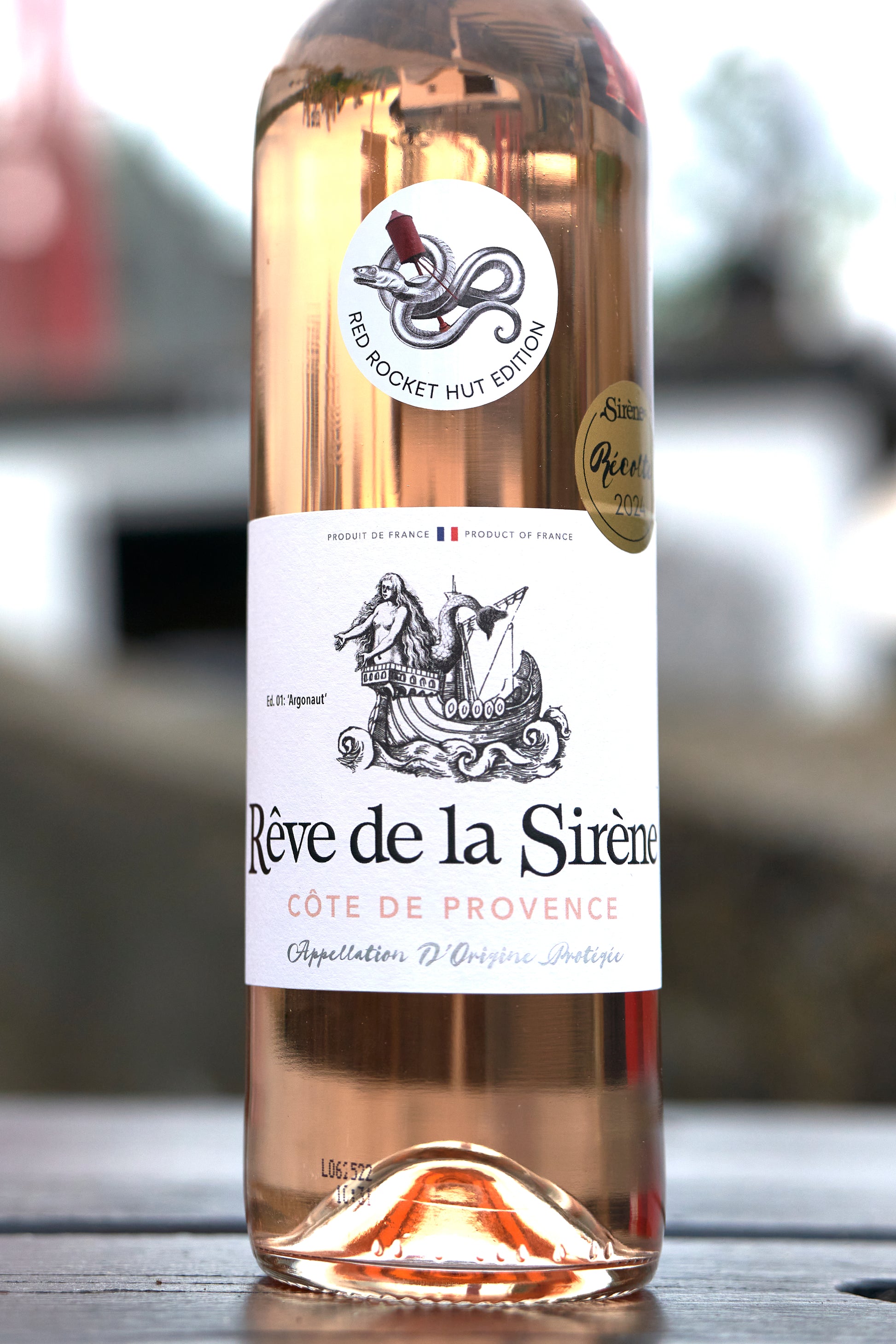 Rose wine bottle labeled 'Rève de la Sèrène' with a blurred background